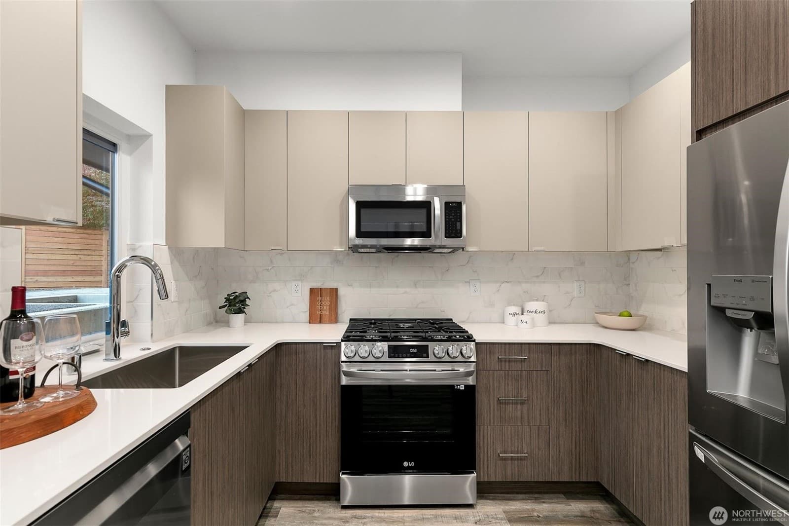 Kitchen from the far side, with the refrigerator and full run of cabinetry