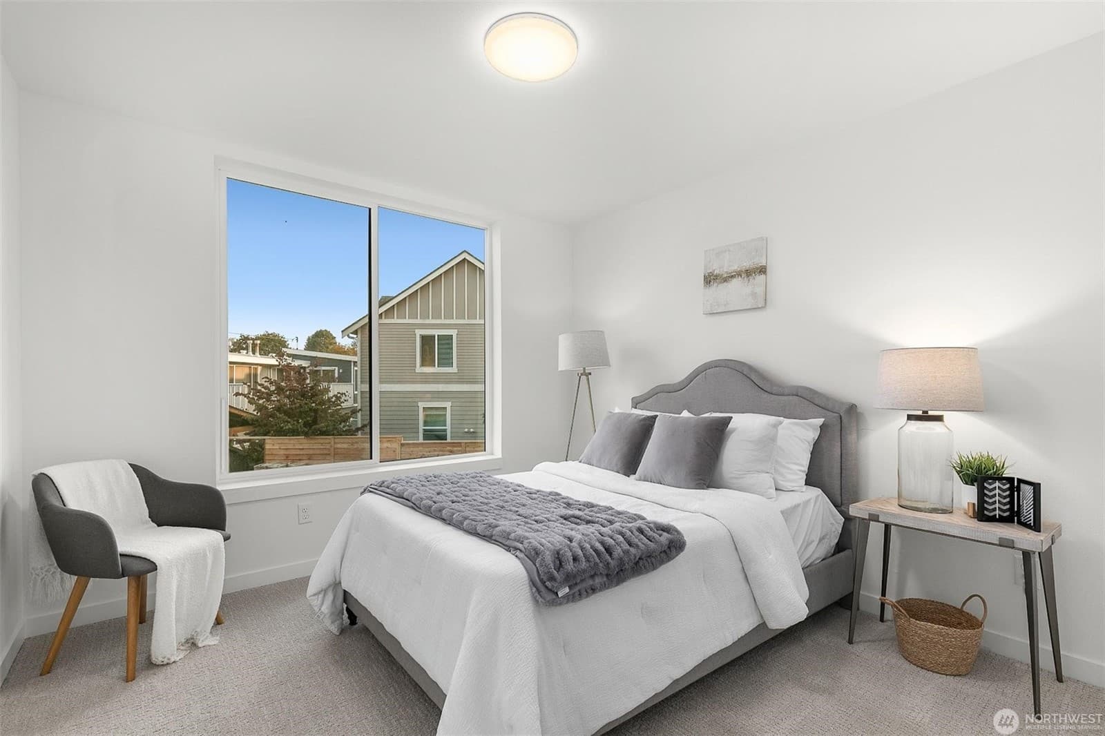 Bedroom with a wide window over the street