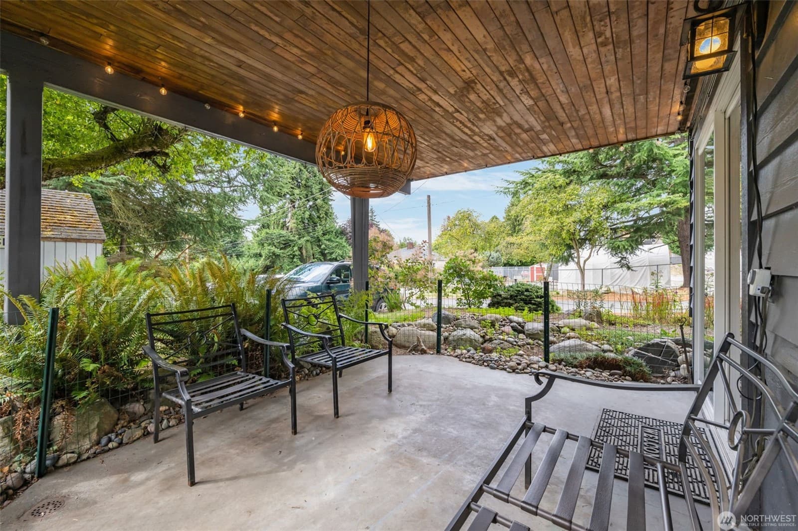 The covered patio from the far end, looking out over the garden