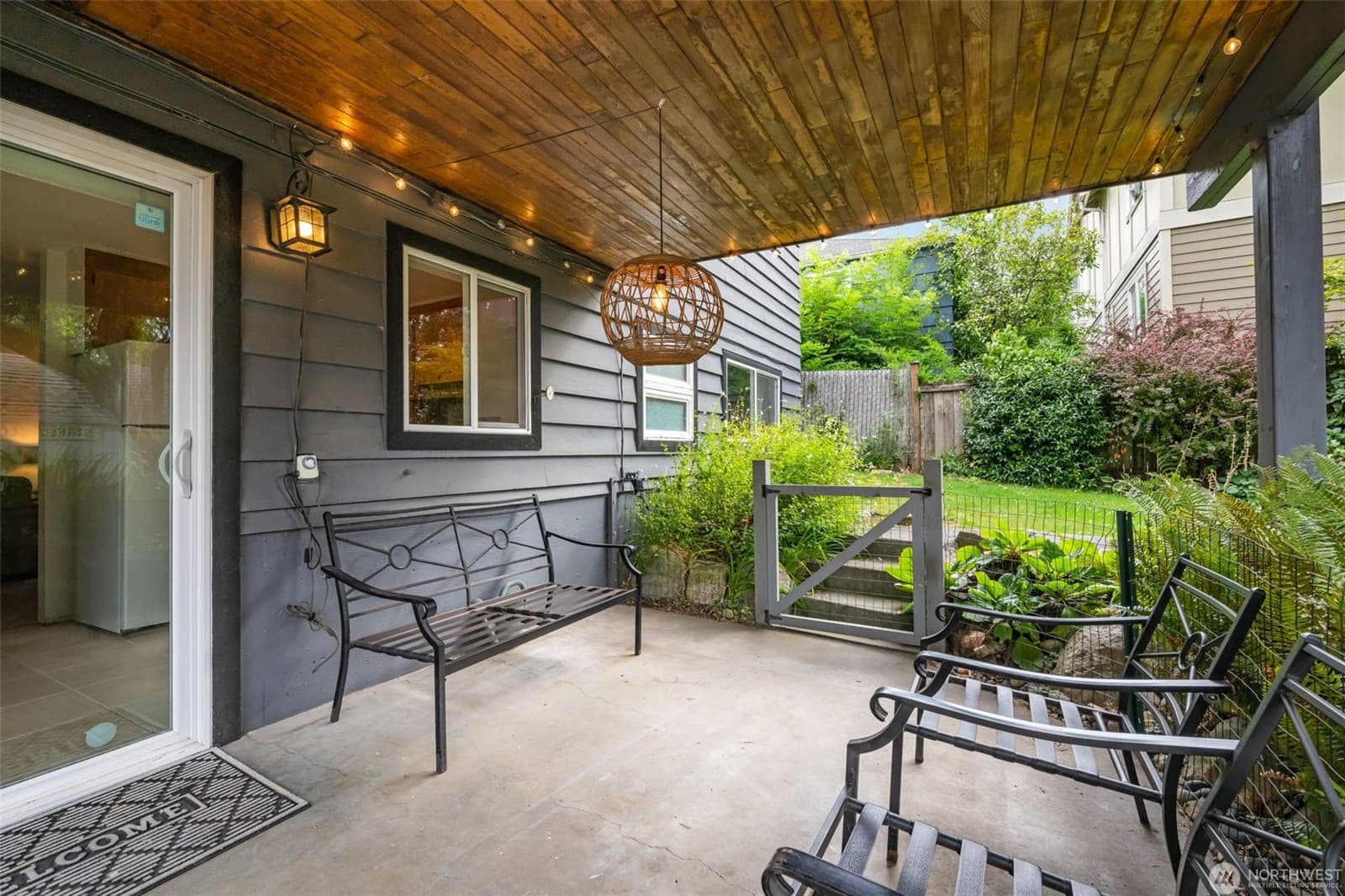 Covered entry with a bench, and the gate through to the garden