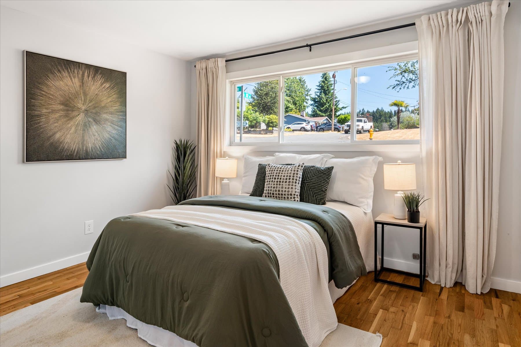 Main-floor bedroom with a wide window facing the front of the house
