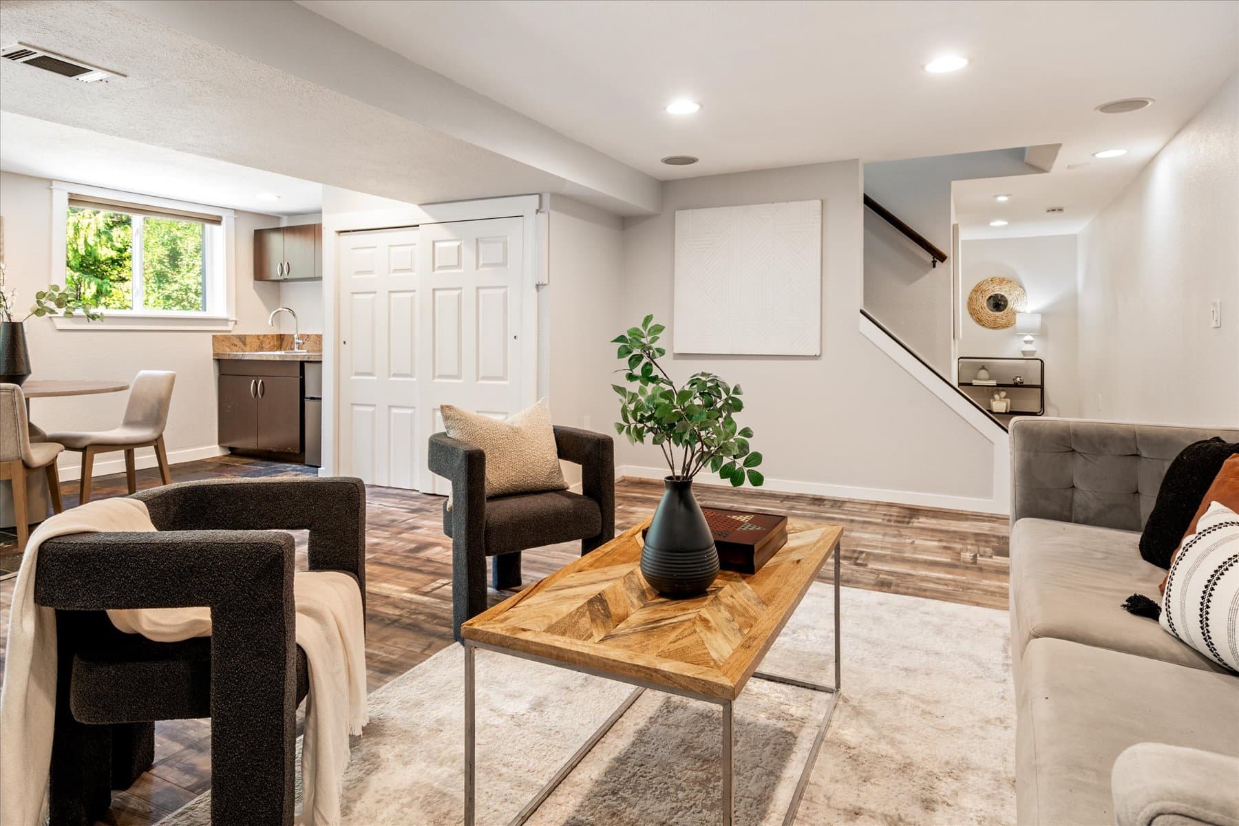 Lower-level bonus room, with the stairway up to the main floor