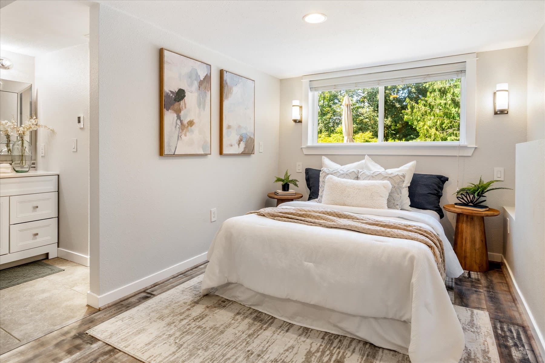 Lower-level bedroom with a wide window and tile floor