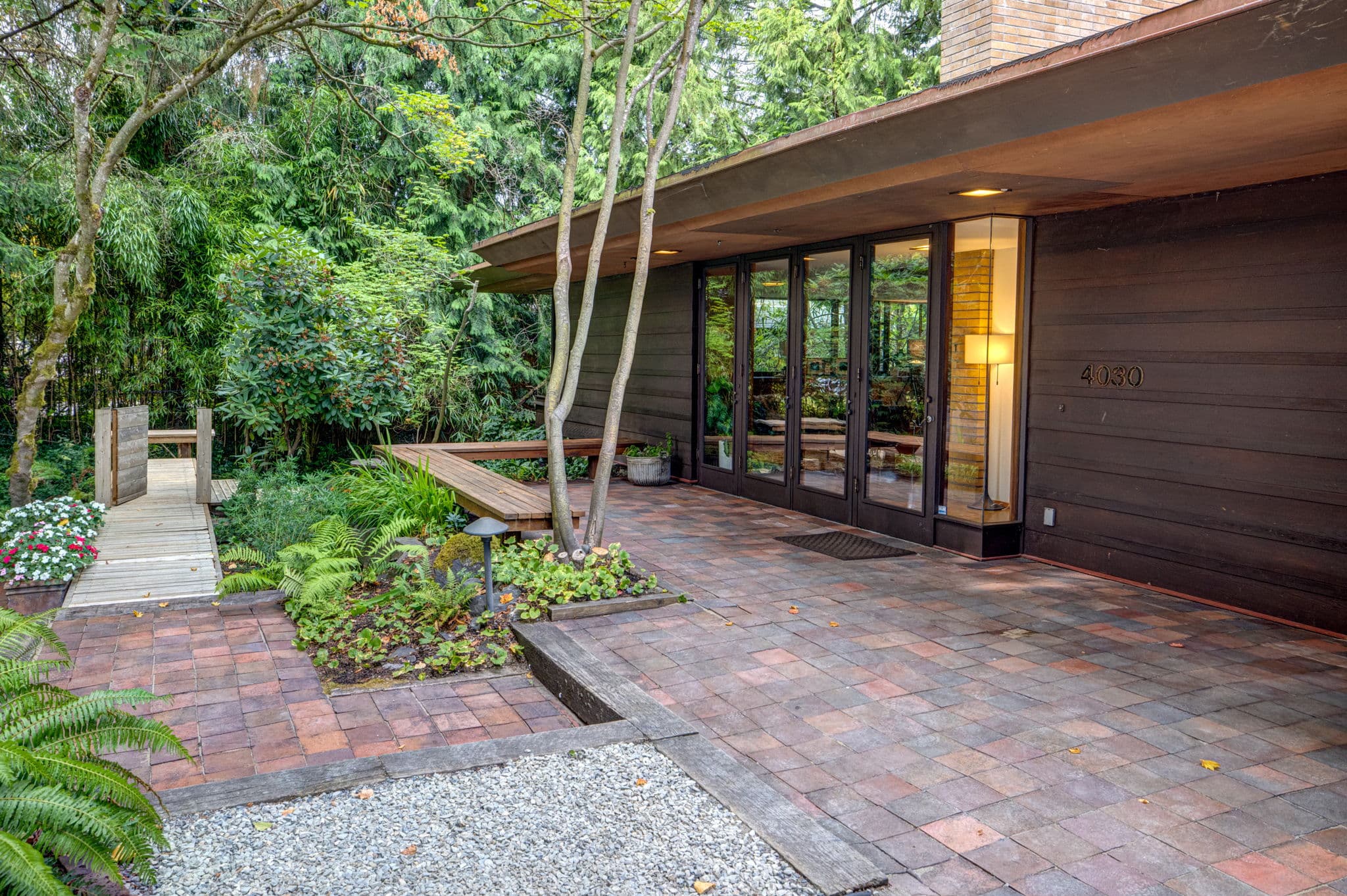 Side elevation with a brick path leading to the entry