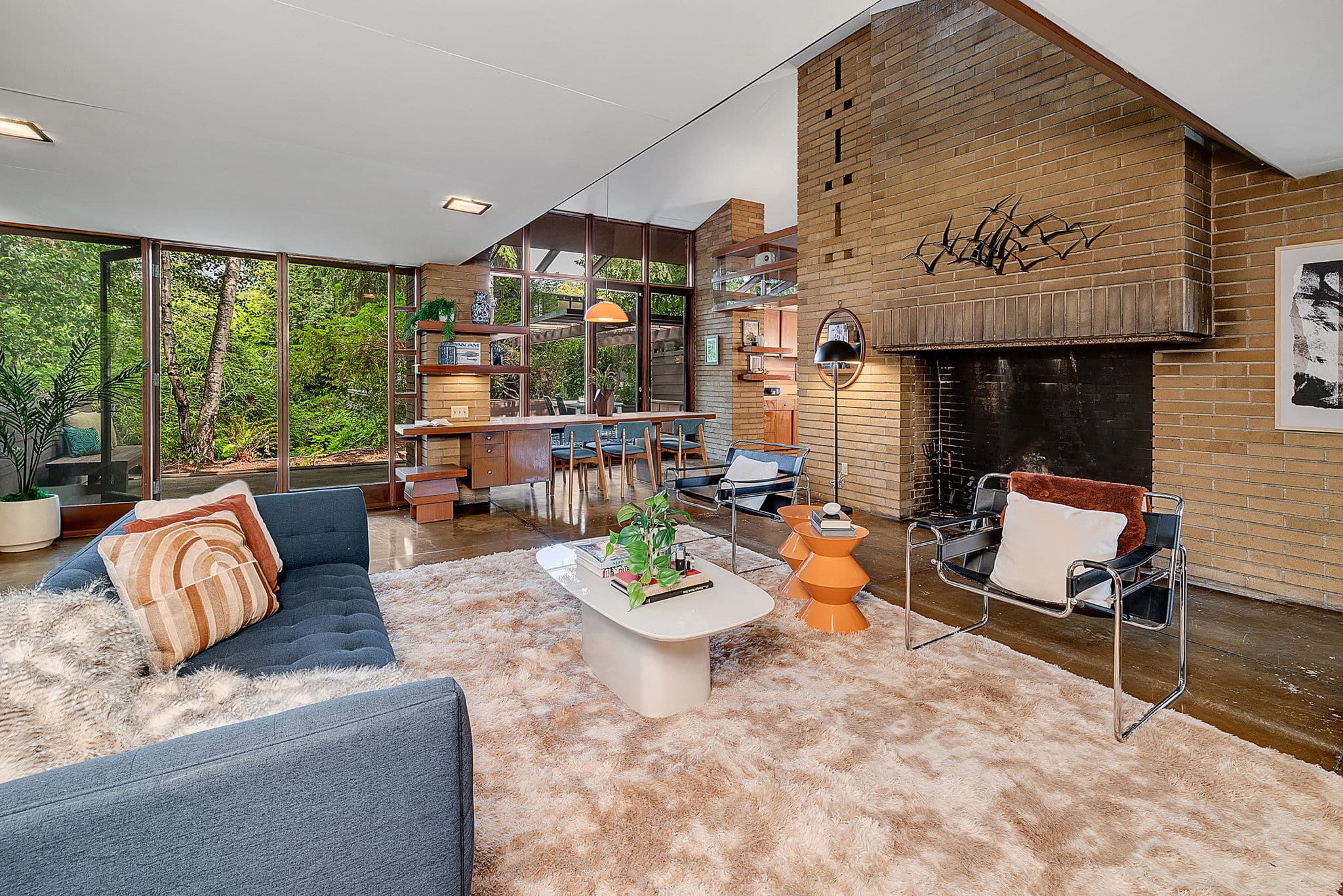 Living room looking toward the brick fireplace, glass running along the far wall
