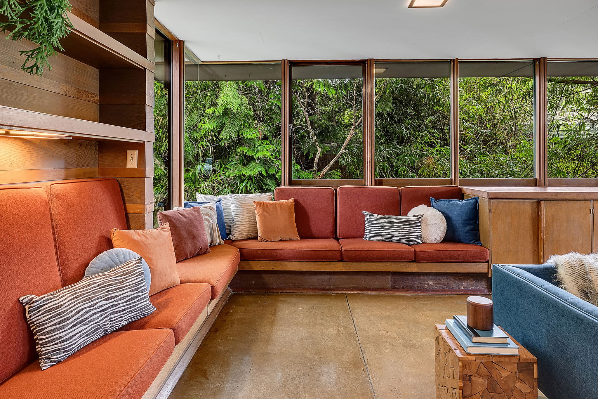 Built-in banquette under a run of corner windows