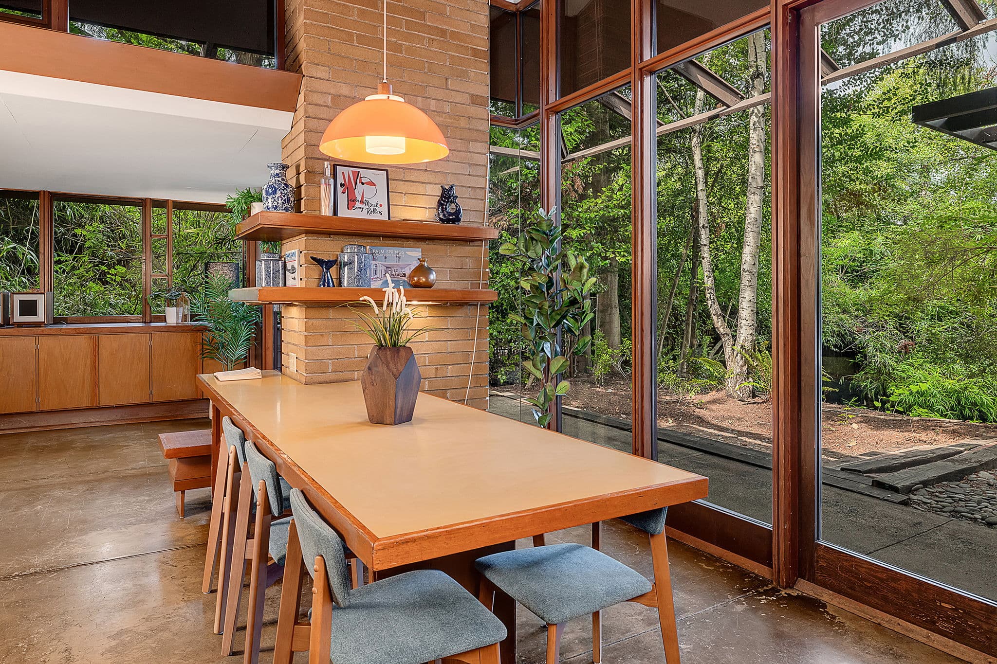 Dining table under a pendant, with glass on two sides