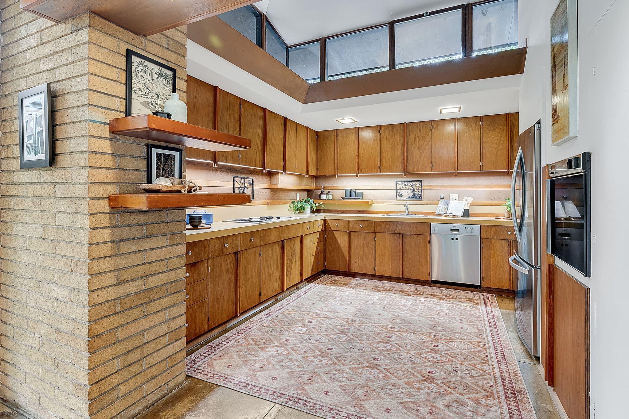 Kitchen with wood cabinetry and clerestory windows above