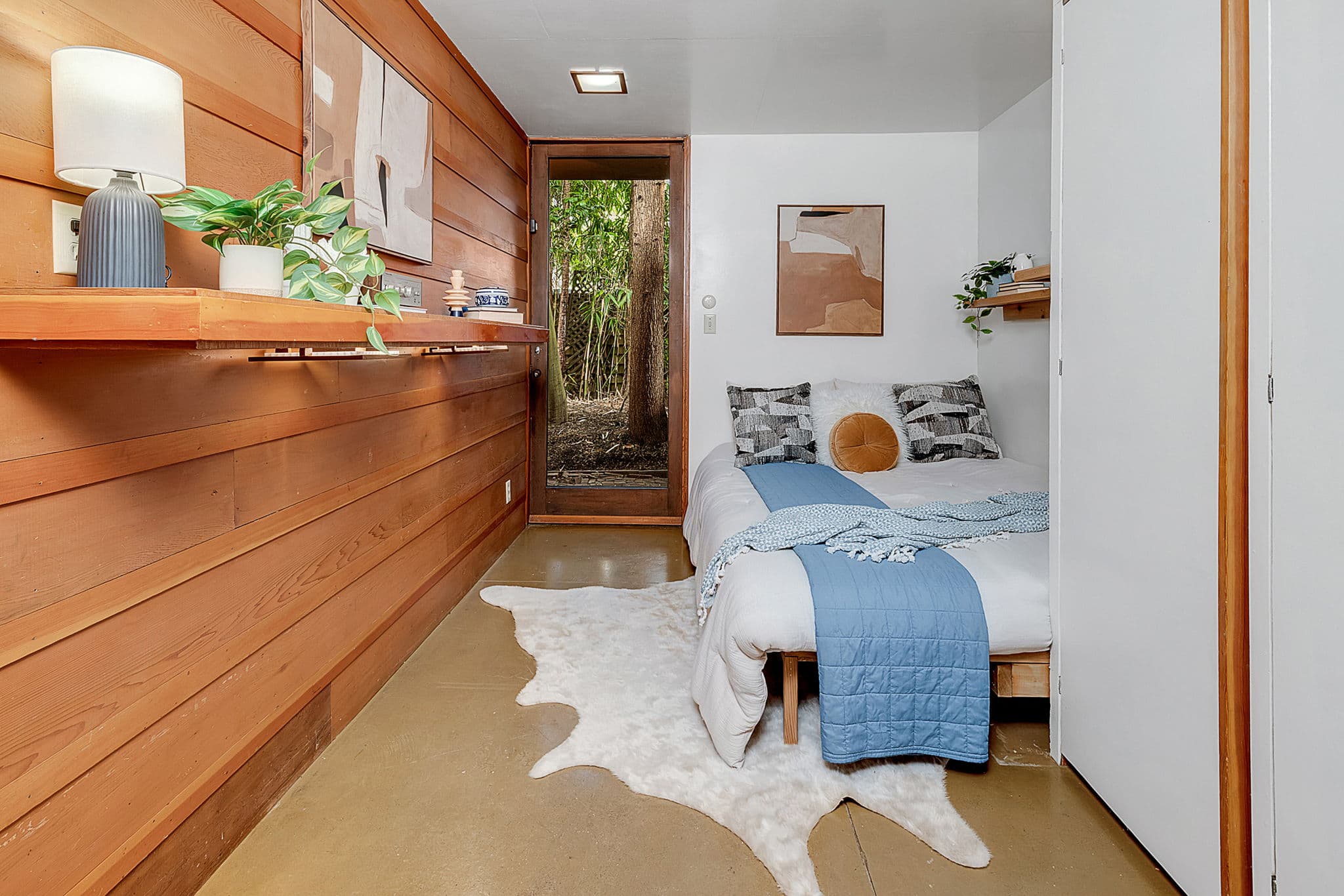 Bedroom with wood walls and a glazed corner