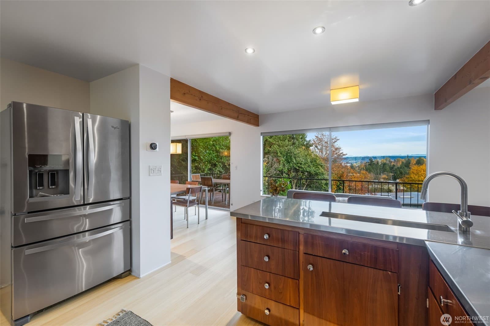 Kitchen looking out toward the deck and the trees beyond