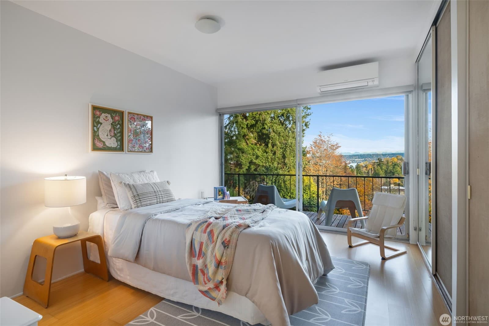 Bedroom with a wall of glass opening onto the deck