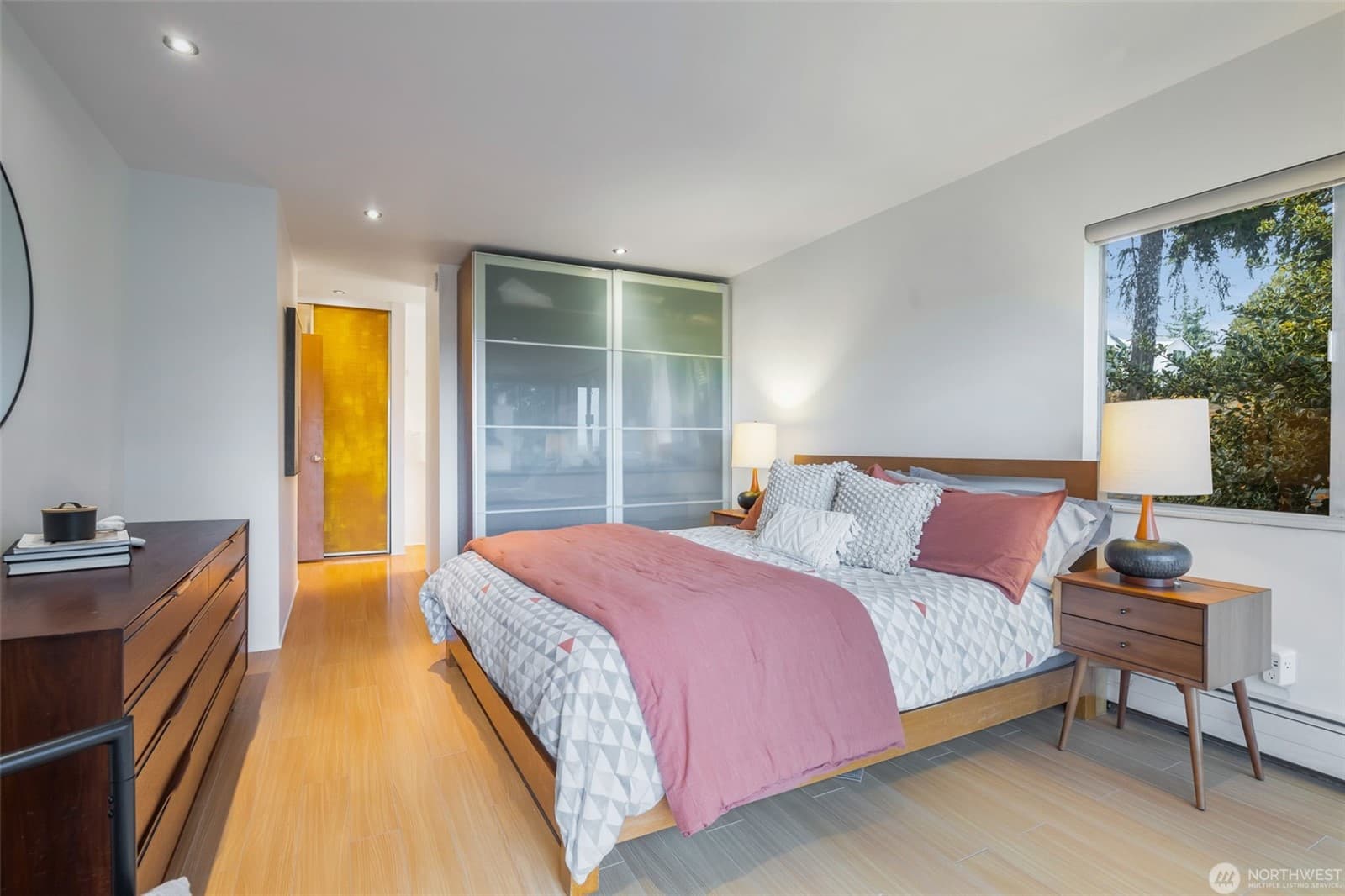 Bedroom with a yellow door and a glazed panel beside it