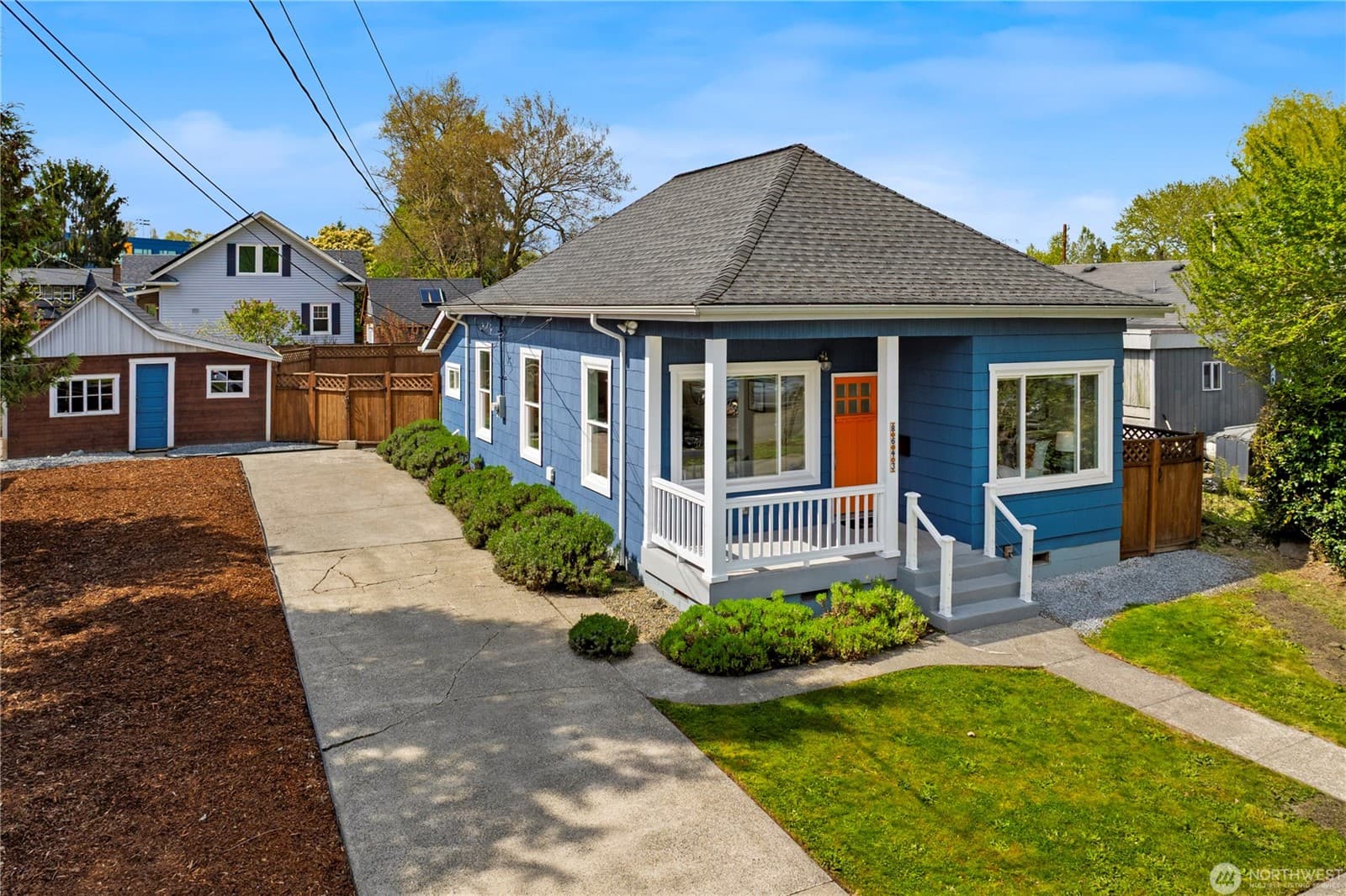 The house straight on from the driveway, with the long side yard running back toward the alley