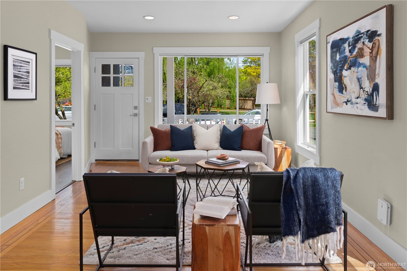 Living room toward the front door, with daylight from windows on two sides
