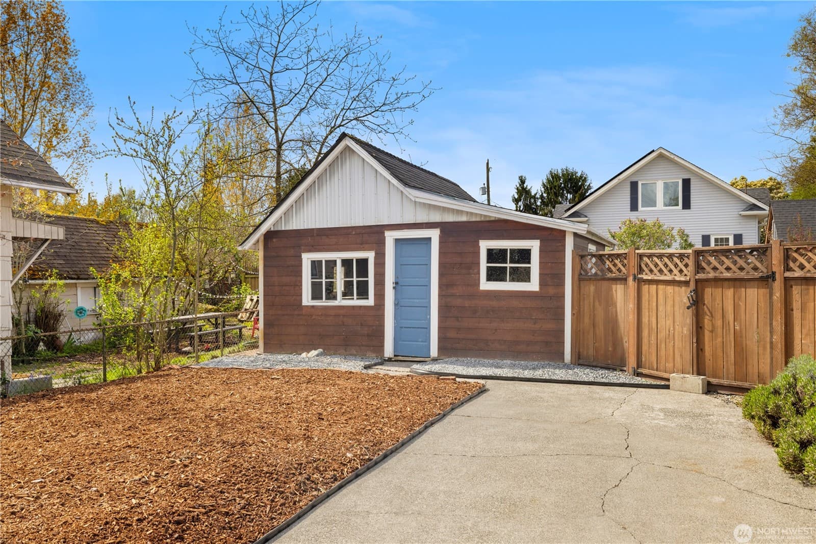 The oversized detached garage at the back of the lot, opening onto the alley