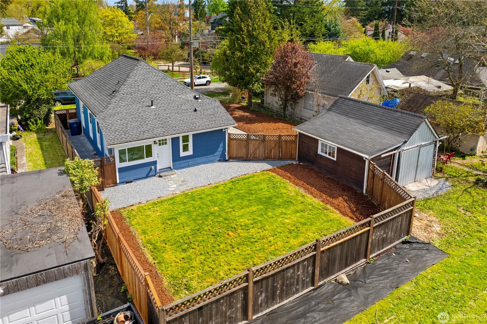 Aerial of the property showing the fully fenced yard, detached garage and alley access